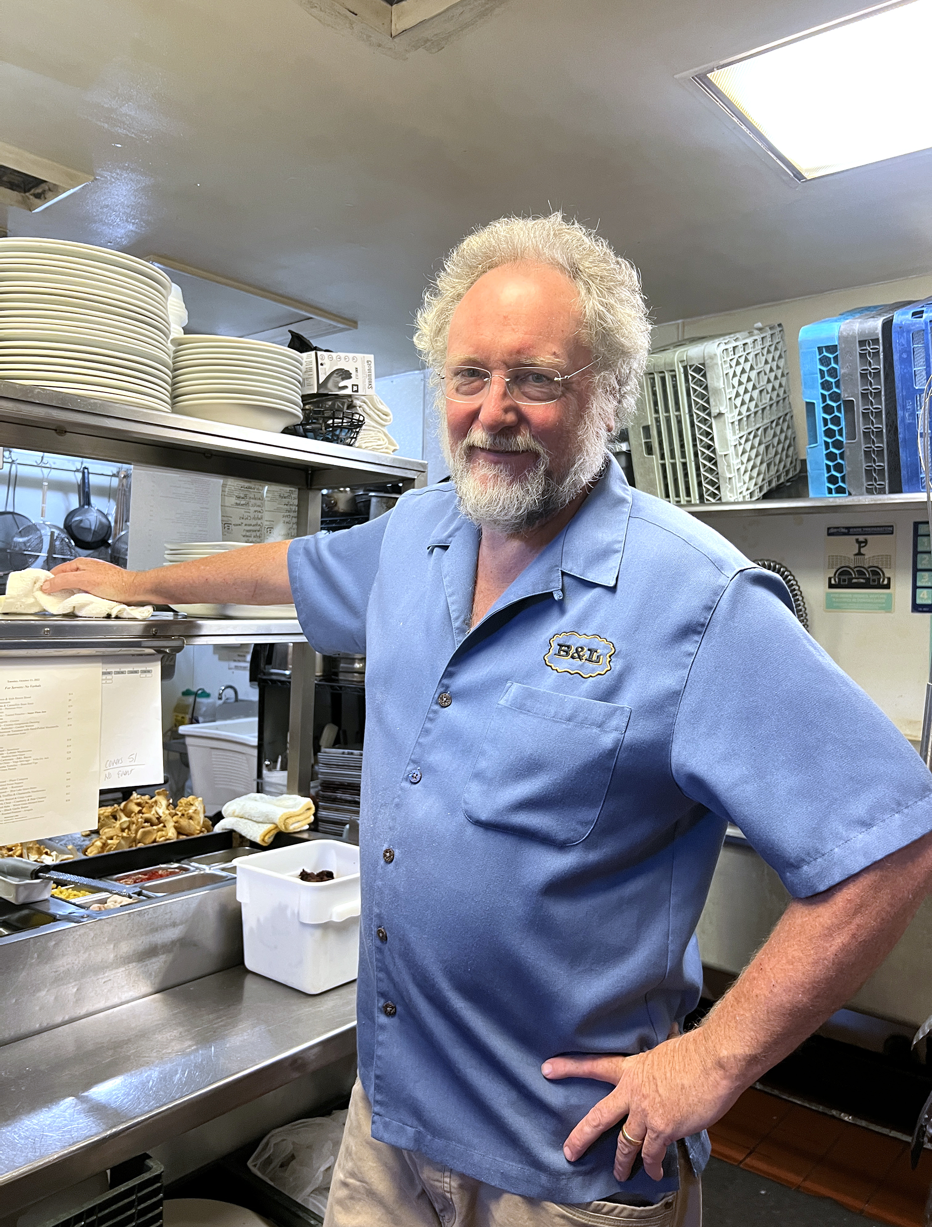 Man in blue shirt stands in a kitchen